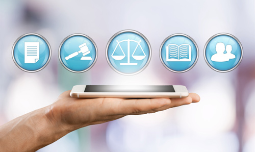 A hand holding a smartphone with computer generated law-related icons floating above to represent law technology